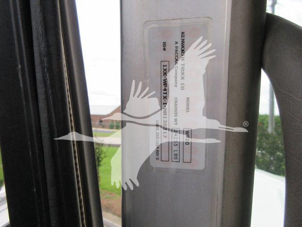 Kenworth W900L door jamb sticker with VIN and stock info, including 1XKWP4TX1NR130317 and U8249, plus truck model and weight details partially visible.