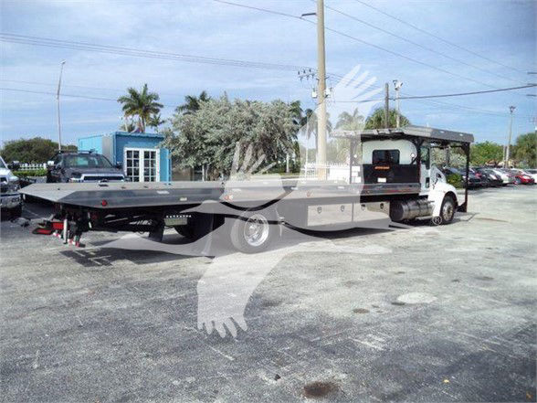 Kenworth T370 tow truck with a flatbed and cab, side view showing extended flatbed and wheelbase.