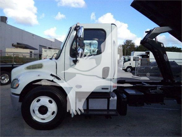 Truck cab of a 2012 Freightliner Business Class M2 106 with a white exterior, single cab, and a hook-lift or container chassis behind.
