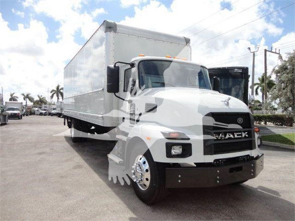 Mack MD6 box truck in showroom lot showing front and driver side with large cargo box.