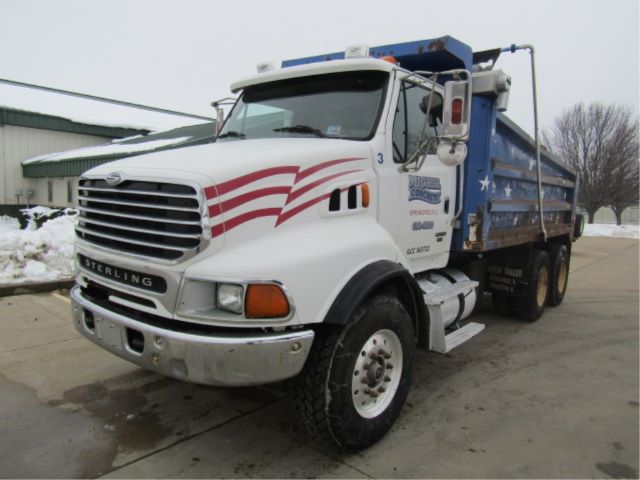 Sterling LT8500 dump truck with white cab and blue dump bed, side decals, front grille, and dual rear wheels.