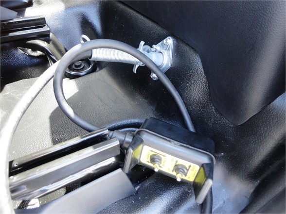 Ram 5500 HD hooklift truck interior showing control switch with wiring harness and label in cabin area.