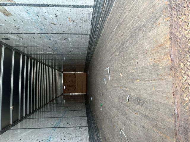 Inside of a 2007 Stoughton dry van trailer showing an empty cargo area with wooden floor, side walls, and rear door at the far end.