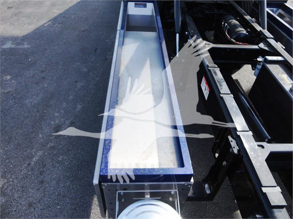 Tow truck chassis frame with metal channel and wheel hub visible; no legible text or specs visible on components.