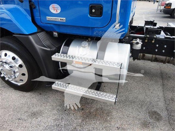 Truck step ladder attached to blue Mack MD6 cab with fuel tank, part of chassis visible.