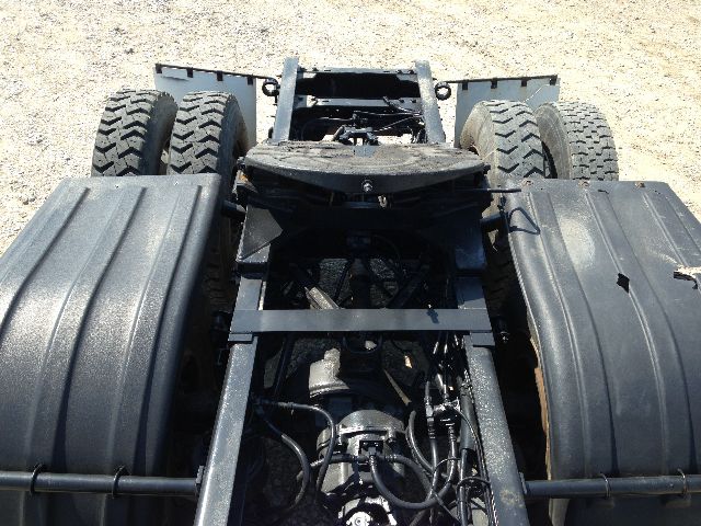 Kenworth truck chassis with dual rear axles and fifth-wheel area; visible hoses and frame rails; no cab or body. Text on listing shows VIN partial 1XKDD49X29J2.