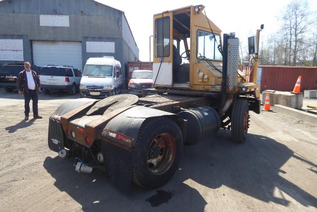 Kalmar 4x2 yard truck chassis and cab view showing rear wheels and yellow cabin.
