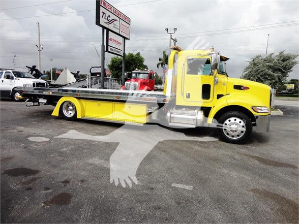 Yellow 2022 Peterbilt 337 tow truck side view with flatbed.