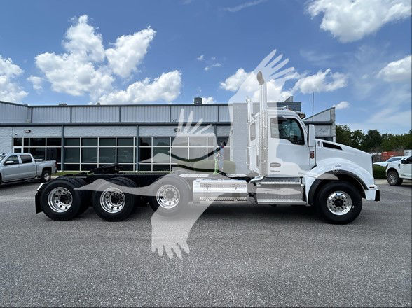 Kenworth T880 conventional daycab tractor viewed from side, showing chassis and dual rear axles. No visible text on components.
