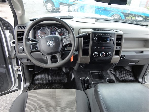 Ram 3500 cabin showing steering wheel and center console with radio and climate controls.
