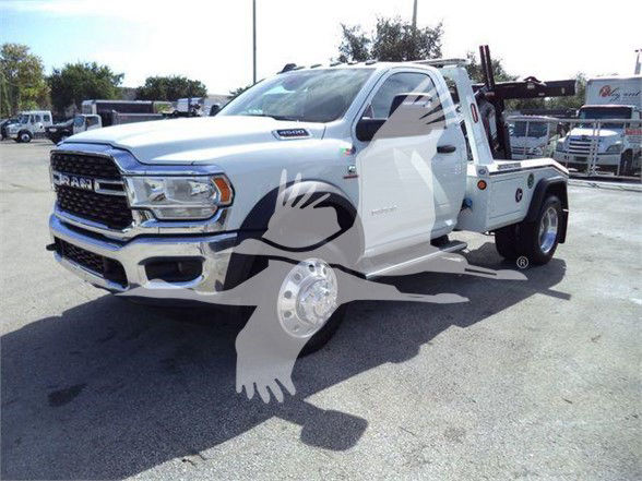 Ram 4500 tow truck in a dealership lot with a decorative overlay; front grille reads RAM, right side shows tow-tower equipment, chrome wheels visible.