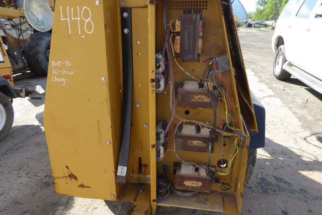 Industrial equipment rear panel with exposed wiring and transformers; yellow metal housing with handwritten '448' and various connectors.