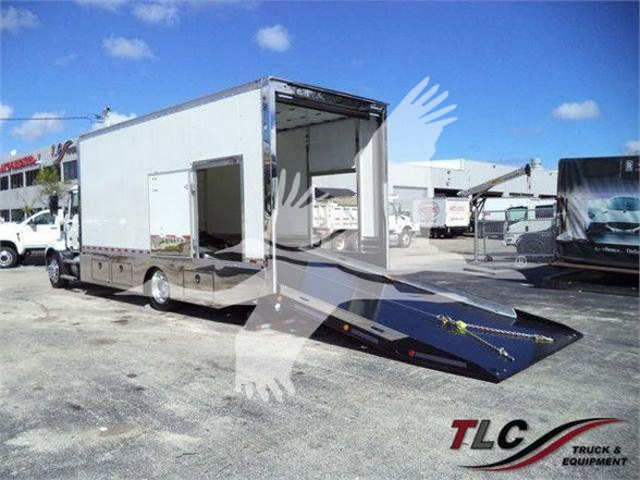 2024 Mack MD6 tow truck with ramped rear in a lot. Text on image includes TLC Truck & Equipment watermark.
