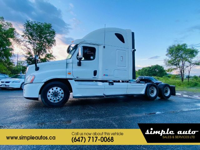 Truck cab of a 2012 Freightliner Cascadia with sleeper, side view, white exterior, cargo area chassis visible.