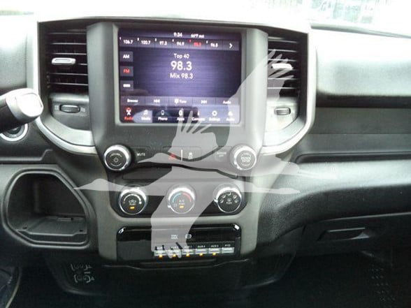 Ram 4500 dash area showing touchscreen infotainment system with radio 98.3 and climate control knobs.