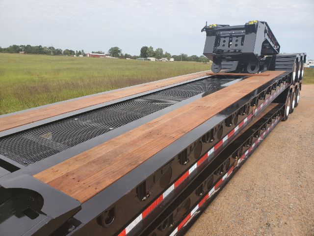 2020 Atoka lowboy trailer showing long steel deck with wood planks and a gooseneck area at the far end.