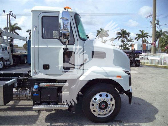 2024 Mack MD6 truck cab side view showing front wheel and door, chassis components, and side step.