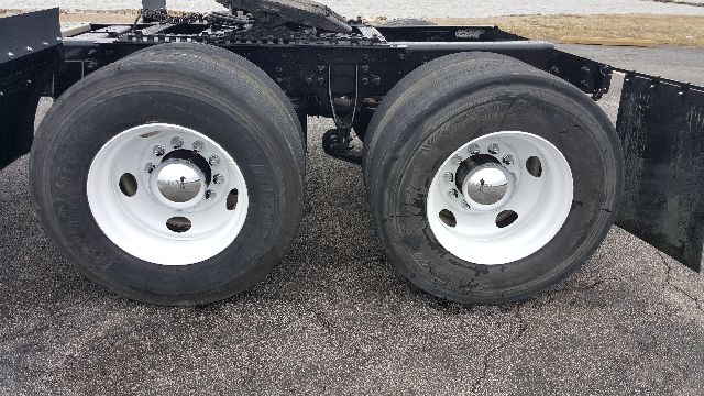 Dual rear wheels on a 2007 International 8600 truck chassis showing white steel rims and black tires.