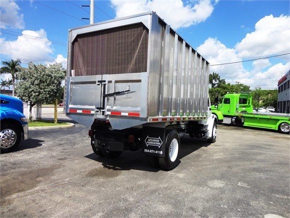 Freightliner Business Class M2 106 dump truck rear view showing cargo bed and rear bumper with silver metallic body.