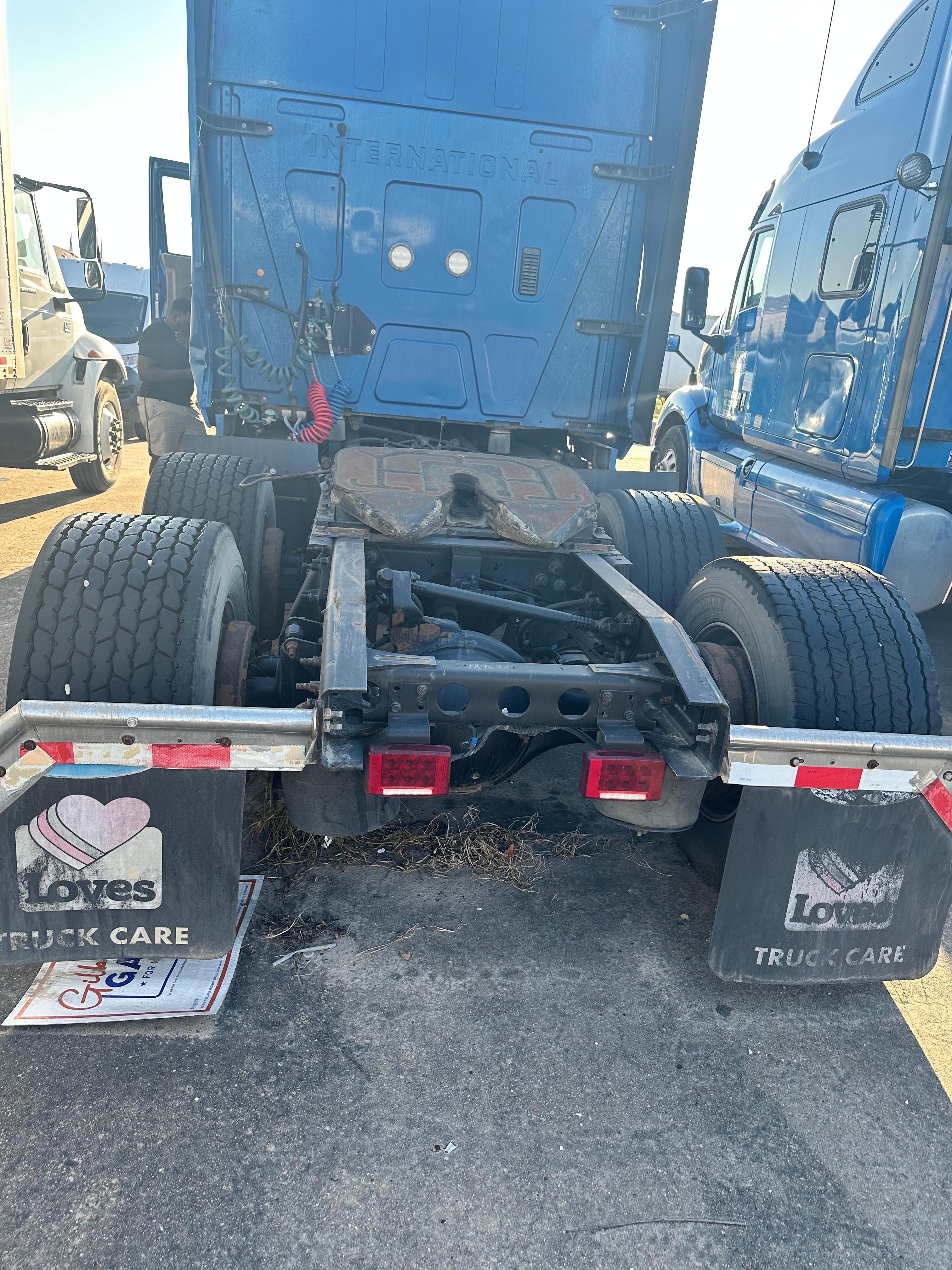 Truck rear view showing fifth wheel and dual rear axles of a blue 2017 International Prostar conventional sleeper.
