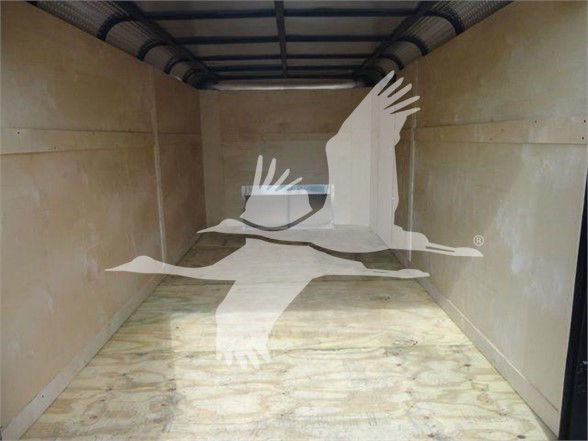 Truck parts listing image shows empty trailer interior with wooden floor and side walls; white watermark of a flying bird logo overlayed across center.