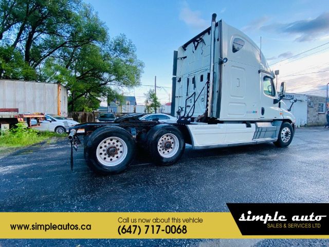 2012 Freightliner Cascadia truck in a lot with cab and sleeper, white exterior, dual rear axles, Simple Auto banner at bottom