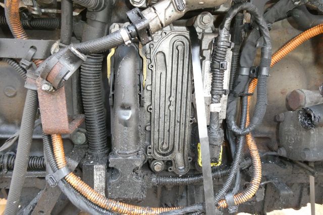 Detroit DD15 engine core showing valve cover and surrounding wiring harnesses and hoses.