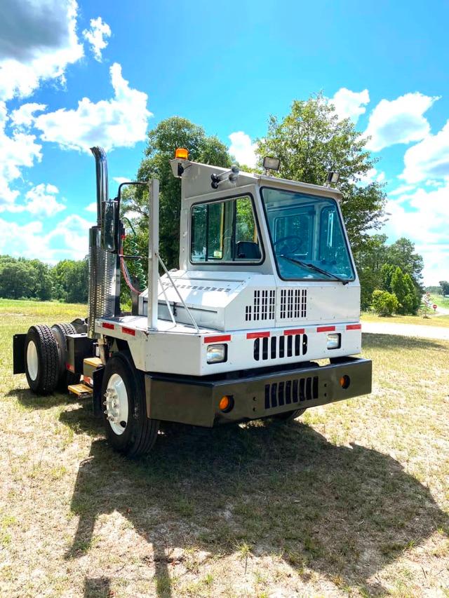 Truck yard unit showing cab-forward view, white Ottawa 50 terminal tractor with black bumper, vertical exhaust, and large windows.