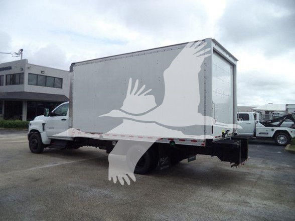 Box truck trailer attached to a Chevrolet Silverado 6500HD chassis showing a large rear roll-up door.