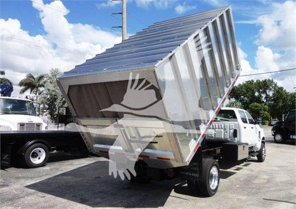 Dump truck dump bed tilted up on a white cab truck, stock number 4X4CV14CHIPPER, International CV model, new condition.