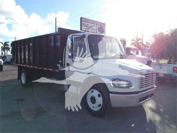 Truck cab and dump bed from Freightliner Business Class M2 106 with front grille and headlights visible.