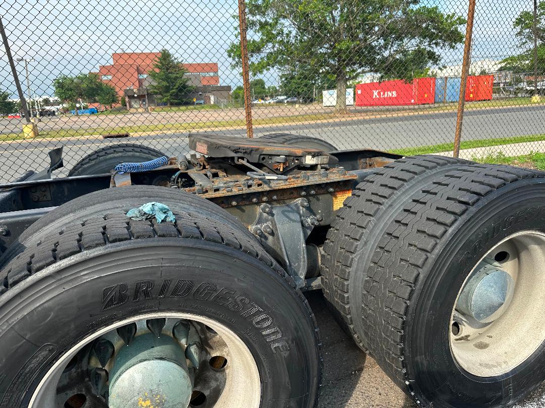 Freightliner Cascadia 2011 tractor truck rear wheels and chassis showing dual rear tires and fifth wheel area.