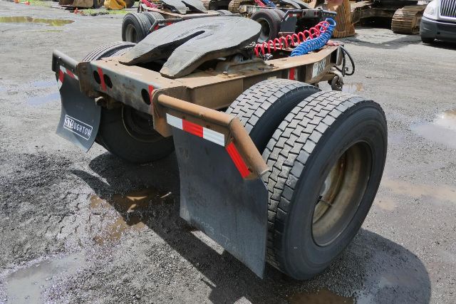 Fruehauf ELFI trailer rear showing dual axles and mudflaps with red/blue coiled air hoses.