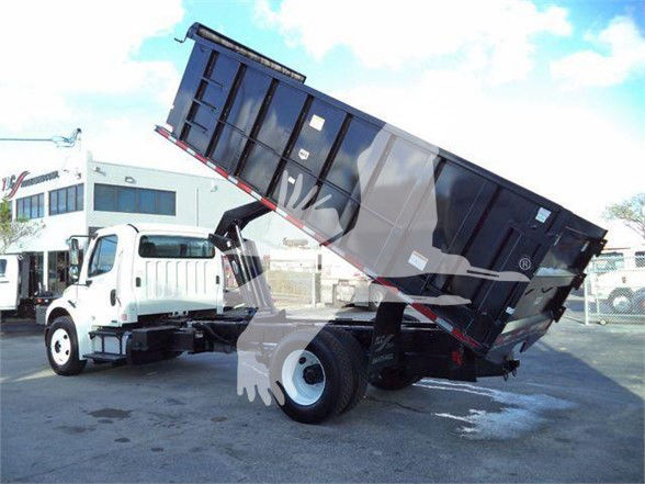 Truck bed dump in raised position showing Freightliner Business Class M2 106 cab and dump bed.