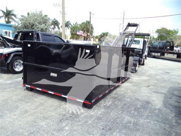 Isuzu NRR refuse truck container bed on trailer with graphic side panel and lowboy style rollout.