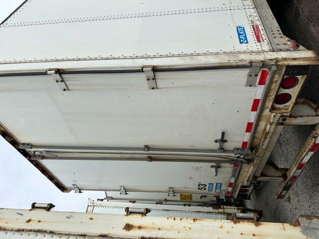 Trailer rear view of a 53' Stoughton dry van with white exterior, doors closed, showing brake lights and reflective tape.