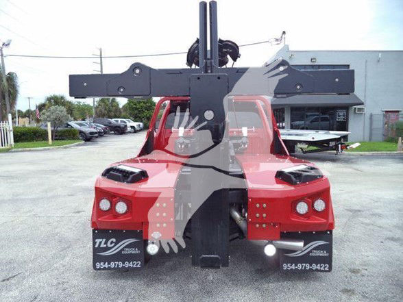 Ram 5500 tow truck rear/mast assembly with hydraulic lifting mechanism and dual rear lights.