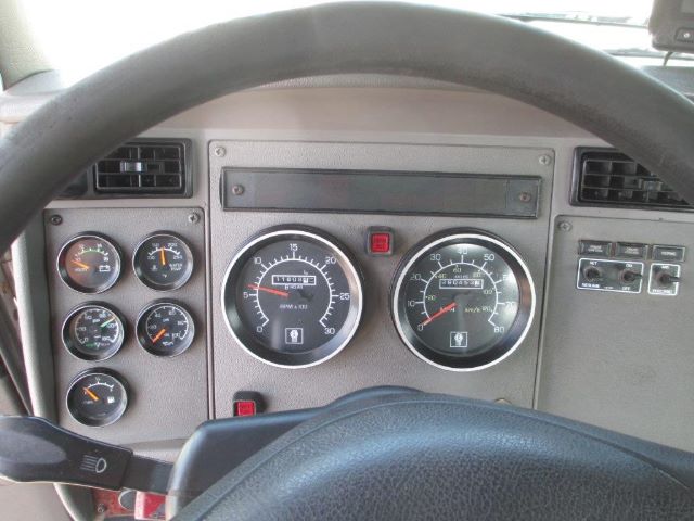 Kenworth T300 truck dash showing multiple gauges and steering wheel in view.