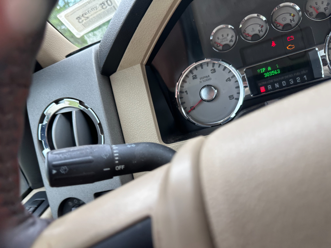 Ford F-450 King Ranch interior showing gauge cluster and tachometer with odometer display.