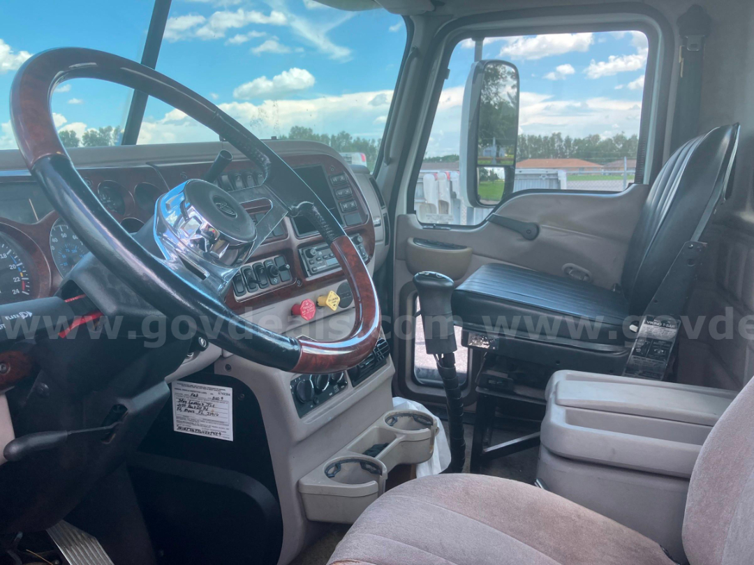 Cab interior of a 2006 Mack CHN613 truck showing steering wheel, dashboard, and driver seat.