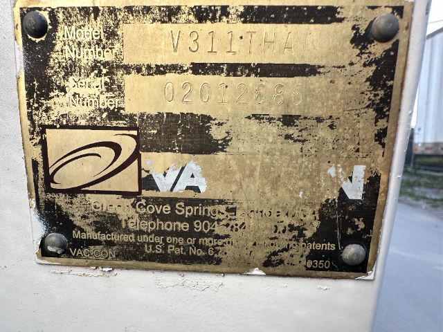 Plate on equipment showing model and serial numbers with worn label, VA logo, and contact text; serial 02012686 faintly visible.
