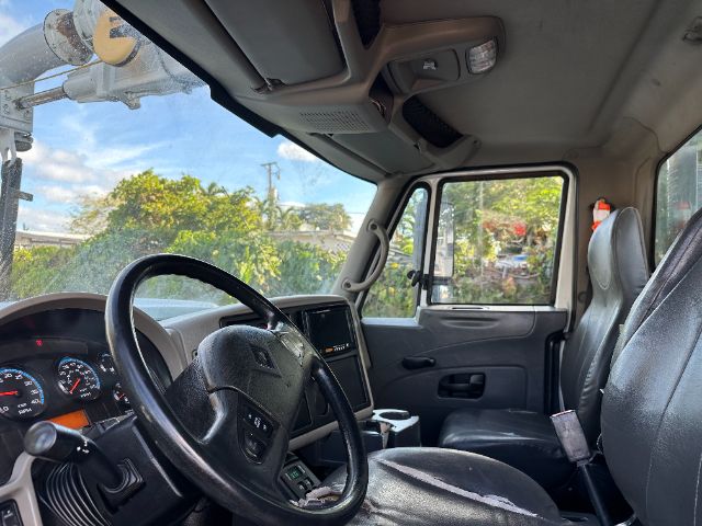 Interior of a 2009 International 7500 vacuum truck cab showing steering wheel, dashboard, and front seats.