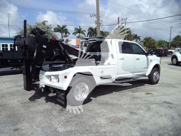 2024 Ram 5500 LARAMIE tow truck shown from side rear angle with heavy-duty equipment mounted in bed and hydraulic lift at back.