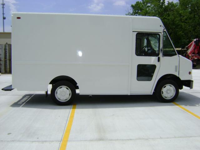 Side view of a white 2007 Freightliner MT45 step van with service doors and cargo area, showing wheel wells and cab forward design.
