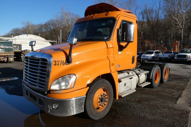 Orange 2017 Freightliner Cascadia 125 conventional daycab tractor with dual rear axles and chrome bumper.