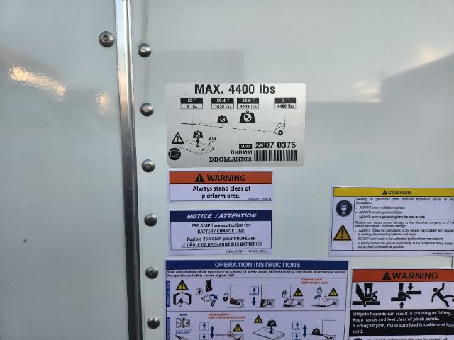 Label plate on Hino truck showing MAX 4400 lbs, with diagrams and warning stickers.