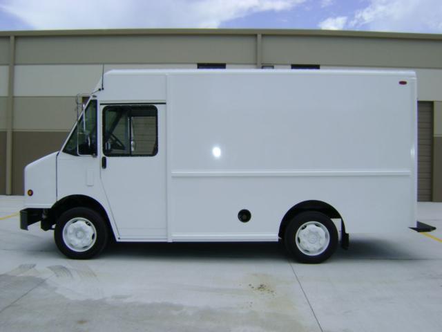 Freightliner MT45 step van side view with white cargo box and cab, showing wheel, door, and cargo area.