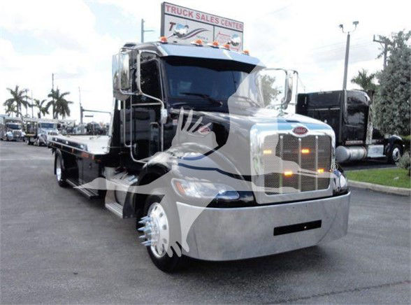 Peterbilt 337 tow truck front and side view with chrome grille and flatbed.