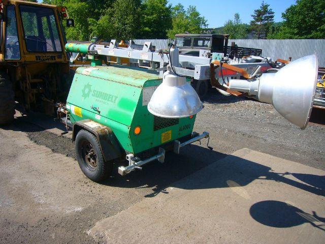 Light-green Terex AL4060D1-S-4MH portable light tower/trailer with large silver floodlight, mounted on a wheeled trailer.