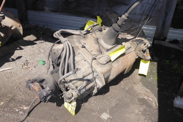 Transmission with cables and shift lever in an outdoor yard.